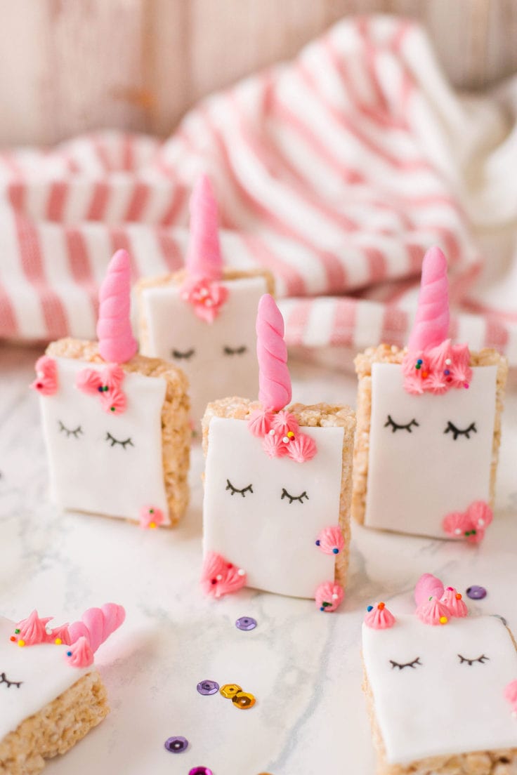 Unicorn Rice Krispies with pink horns and frosting decorations.