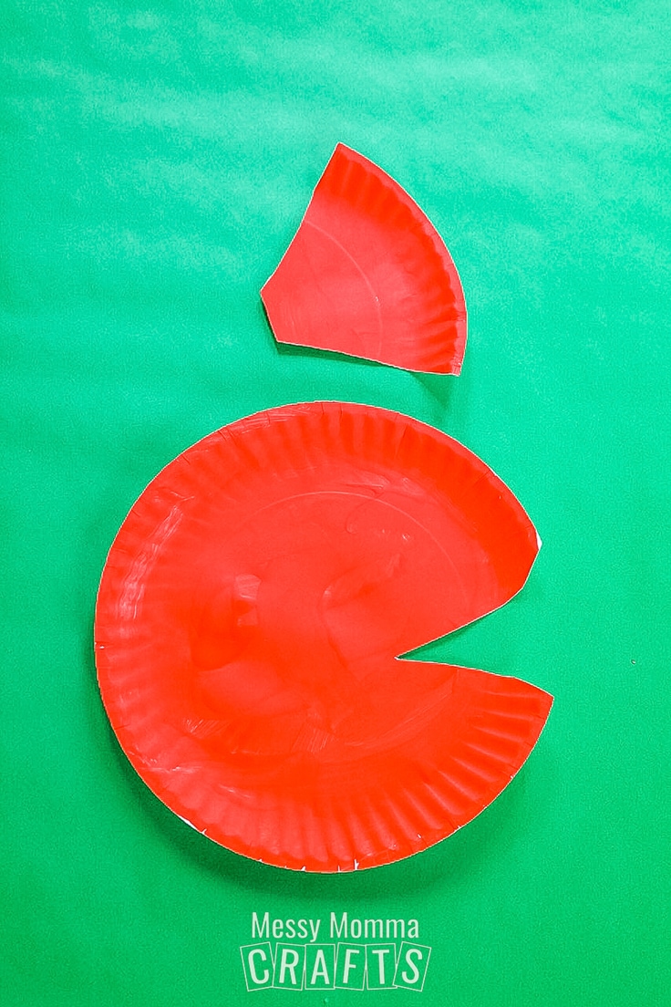 A red paper plate with a pie slice cut out of it.