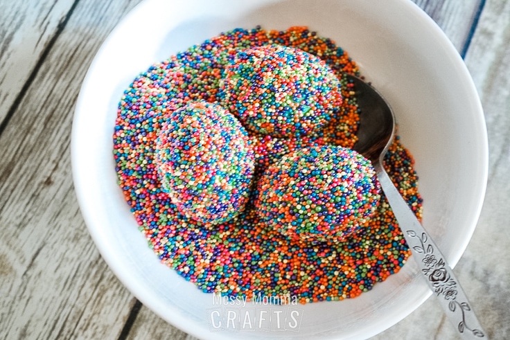 3 eggs in a bowl covered in sprinkles.