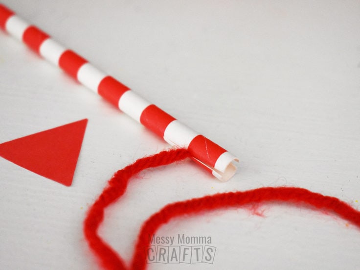 Red and white paper straw and yarn.