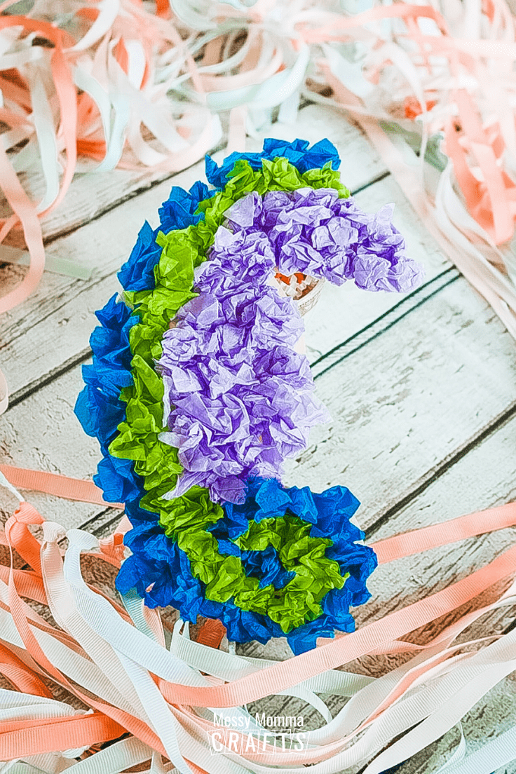 Crumpled blue, green and purple tissue paper seahorse.