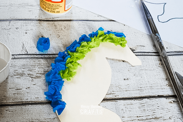 Add crumpled tissue paper in rows on the seahorse.