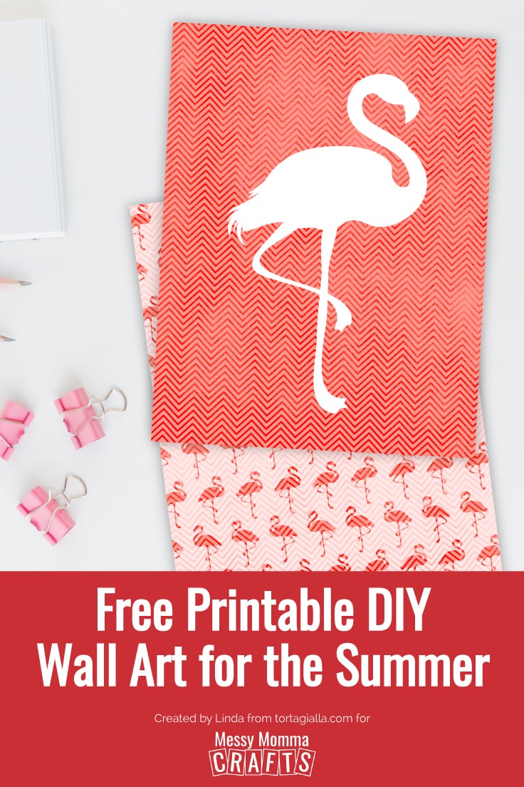 Preview of free flamingo wall art printable download on desk with notebook, pencils and clips.