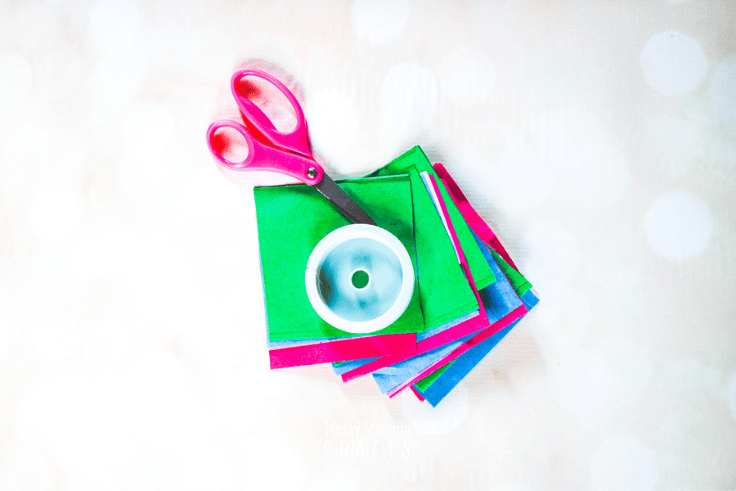 Tissue paper in neon colors, scissors, and floral wire.