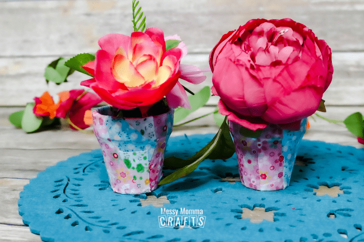 Flower pots decoupaged with fabric in blue and pink.