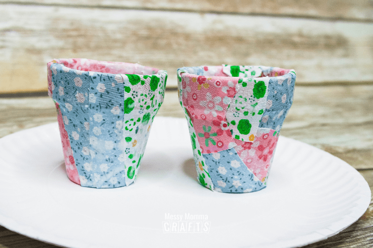 Pink, blue, and green flower-print fabric on small flower pots.
