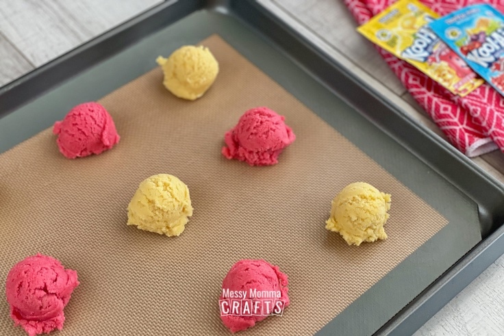 Pan of Kool-Aid cookies dough drops in alternating colors.