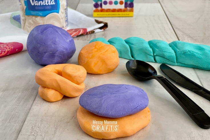 Purple, Orange & Teal frosting Play Dough set up for child's play.