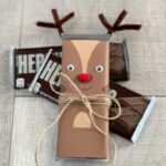 Adorable Reindeer Candy Bar ready to give as a gift with two chocolate bars in the background.