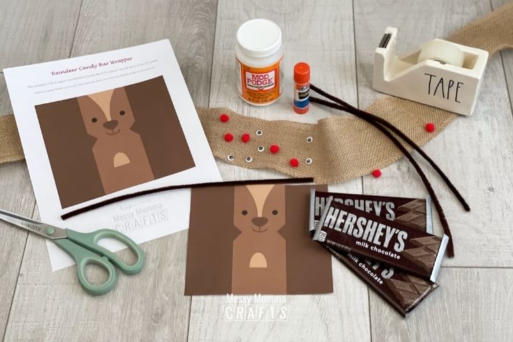 Supplies needed for Reindeer Candy Bars on a wood background.