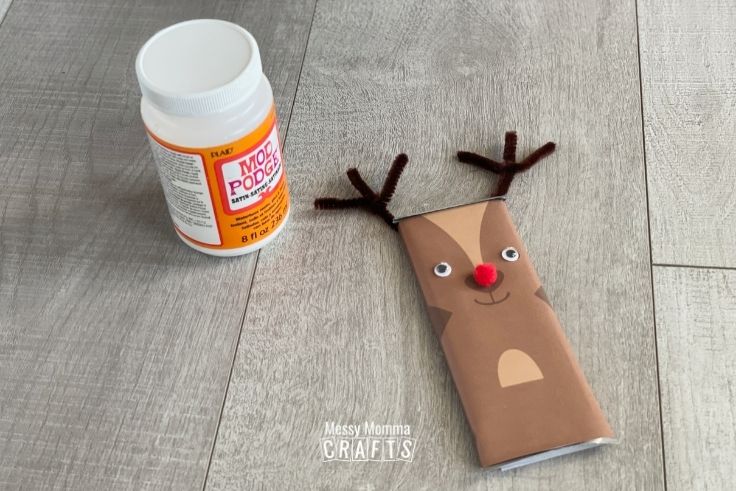 Reindeer Candy Bar on a wood backdrop with a bottle of Mod Podge.