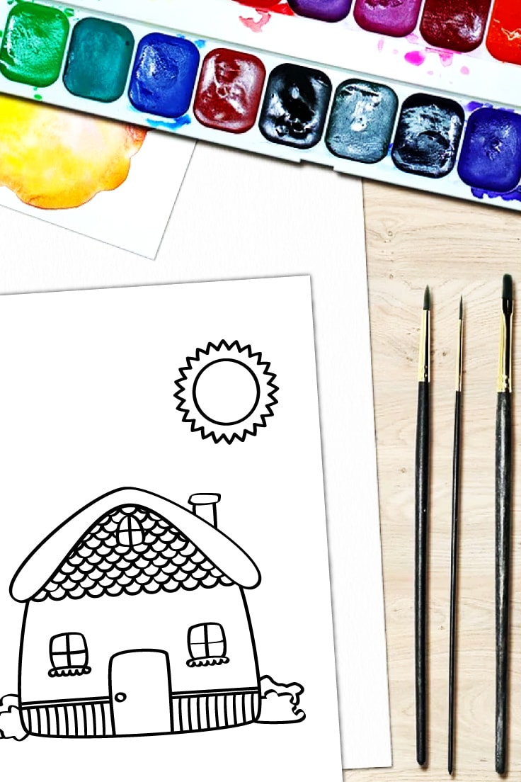 Preview of cute house and sun coloring page printable on white background of desk with paintbrushes and watercolor paint palette.