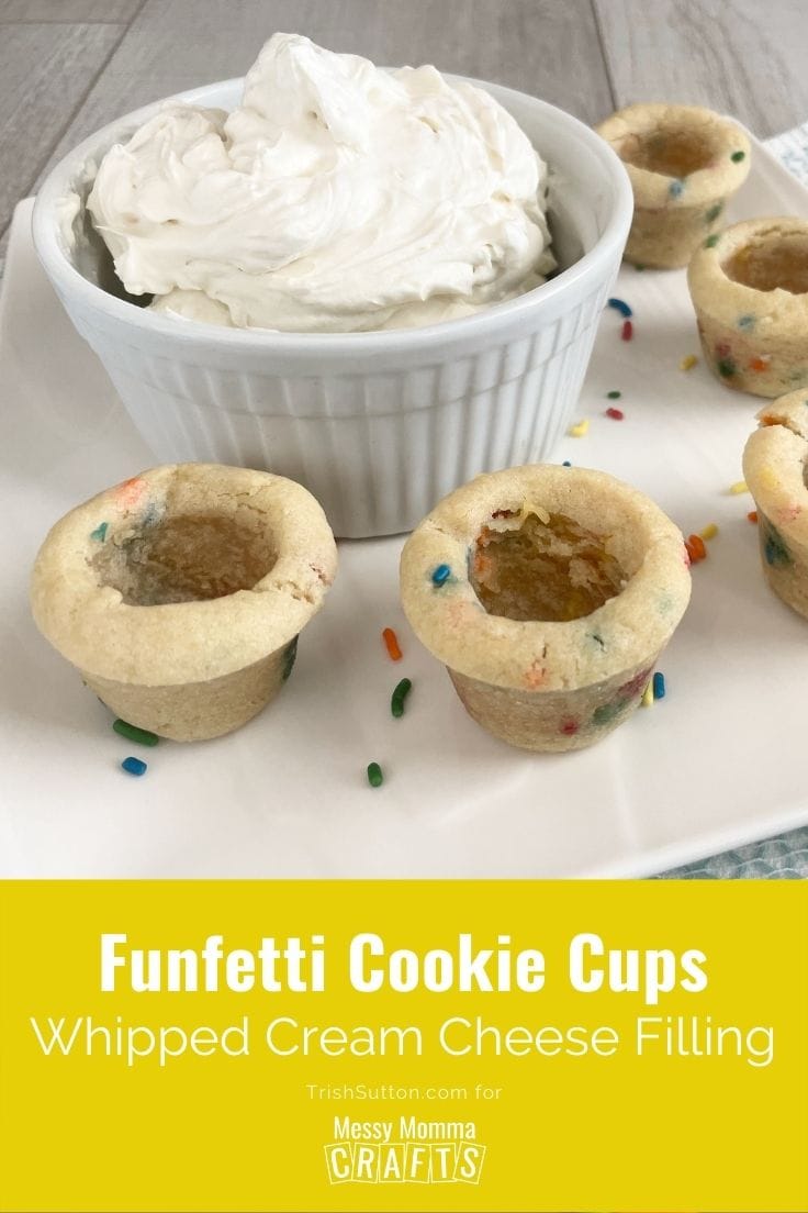 Cookie cups on a white plate with a bowl of whipped cream cheese filling.