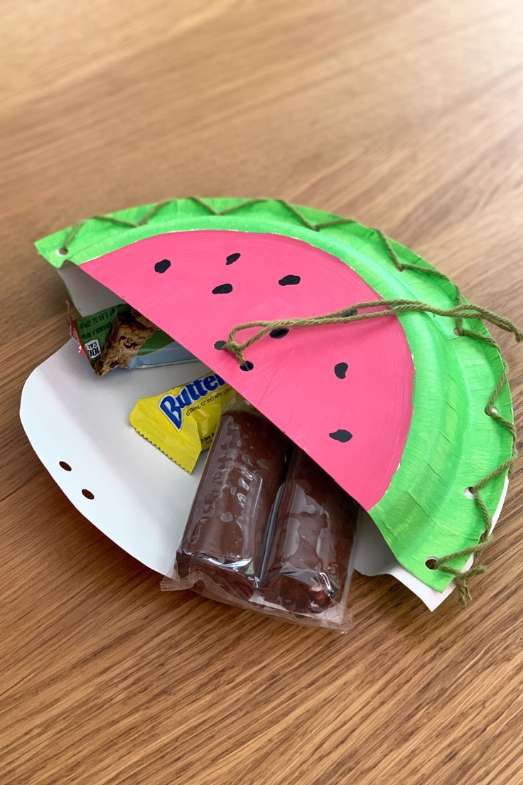 Paper watermelon pouch filled with kids snacks and candy.