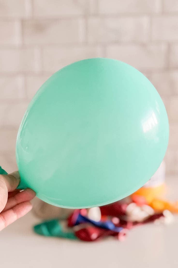An inflated aqua-colored balloon