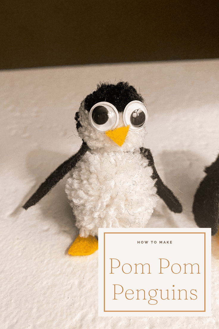 pom pom penguin with googly eyes, a felt triangle nose and two felt wings