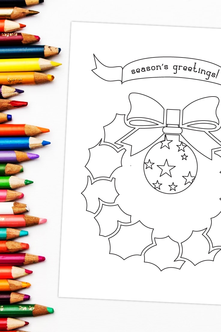 Preview of a season's greetings wreath coloring page on white background with row of colored pencils on the left edge. 