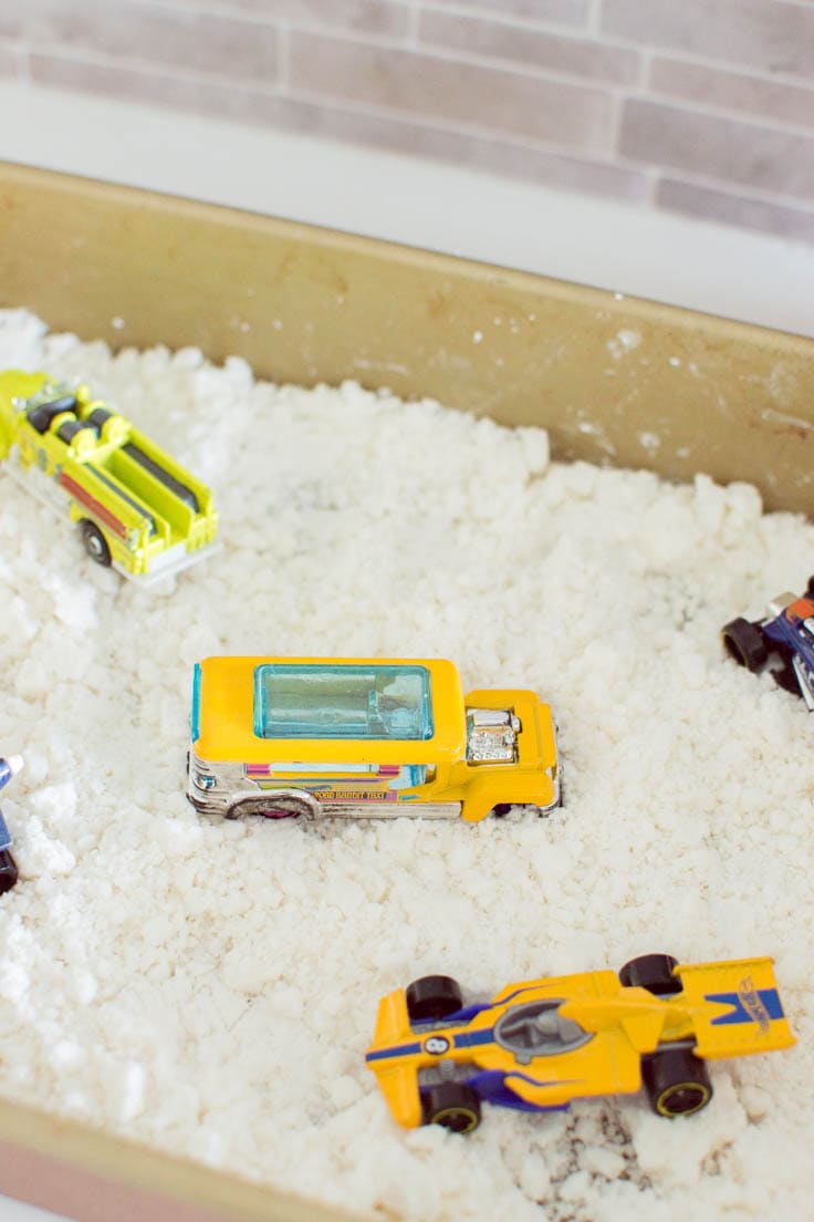 A closeup of a mini toy bus, sitting in DIY fake snow.