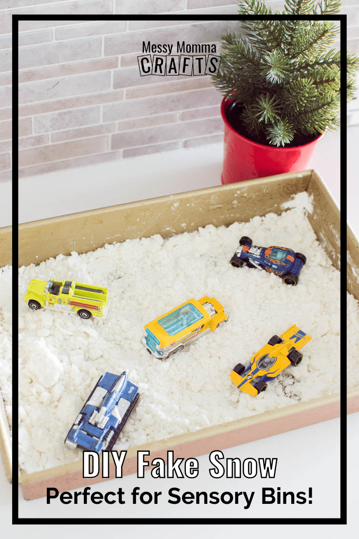 Aerial view of DIY Fake Snow for Sensory bins, sitting in a baking pan with some Hot Wheels cars.