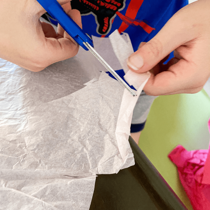 Child cutting pick tissue paper