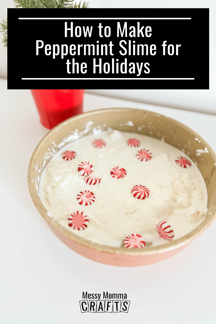 White oobleck slime covered with peppermint candies, in a round cake pan with a mini Christmas tree in the background