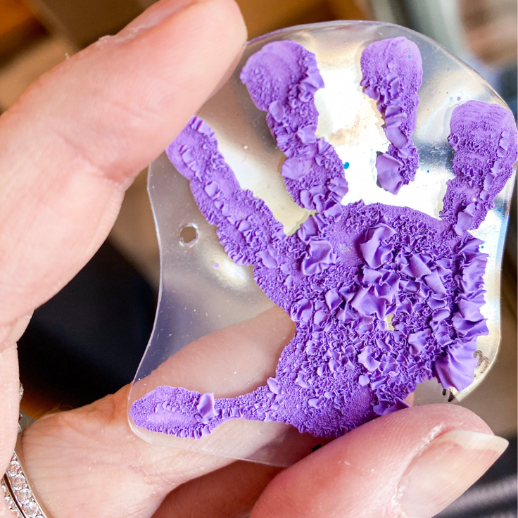 Purple handprint with the paint peeling
