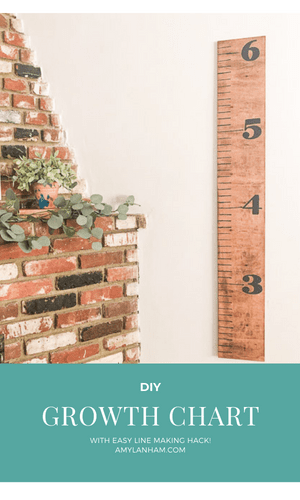 Growth chart hanging next to a brick fireplace
