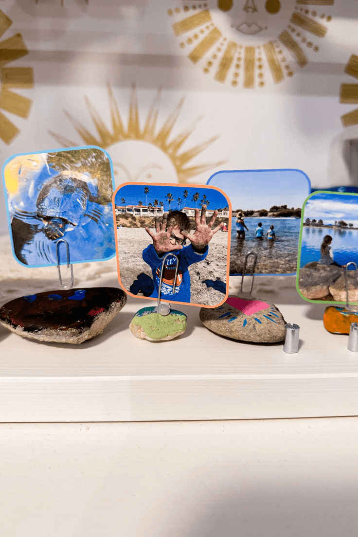4 painted rocks sitting in a row holding pictures