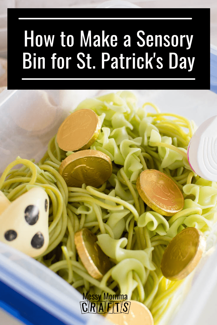 Close up view of a Green St. Patrick's Day Sensory Bin with cooked green pasta and a variety of small toys