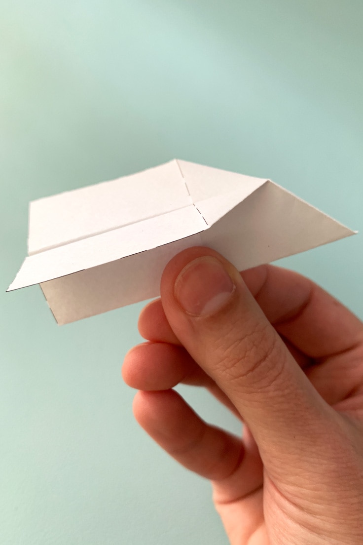 A simple arrow-shaped folded paper airplane.