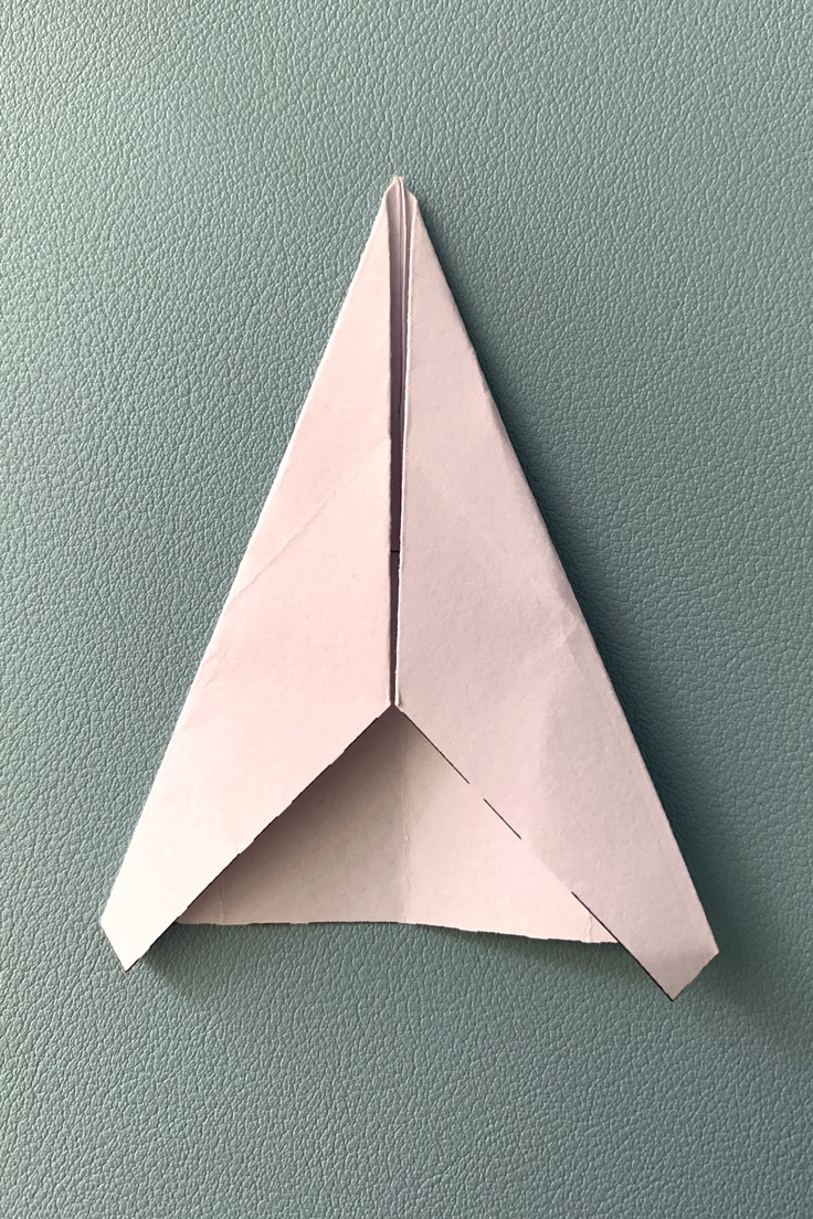 Paper with top folded into a sharper triangle.