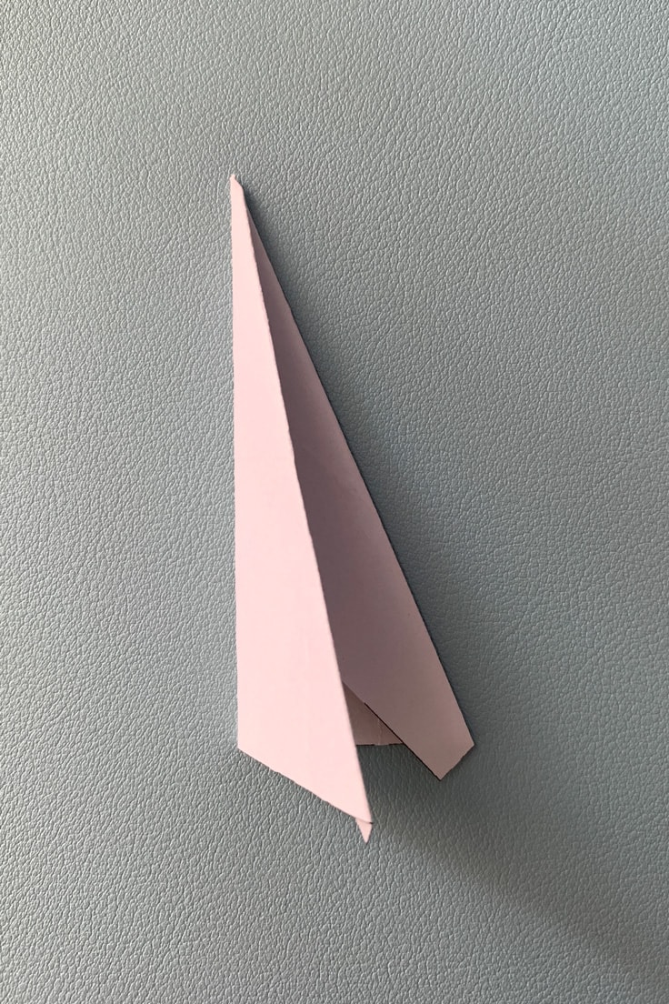Paper triangle folded in half.