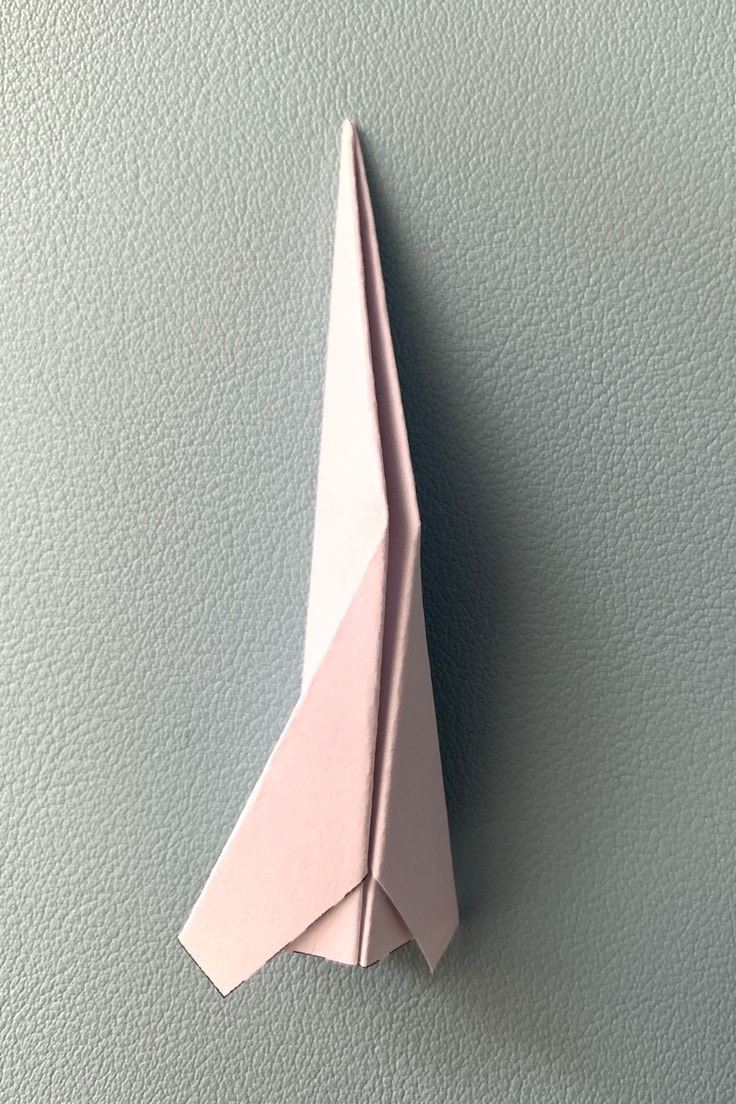 Paper triangle folded to create wings.