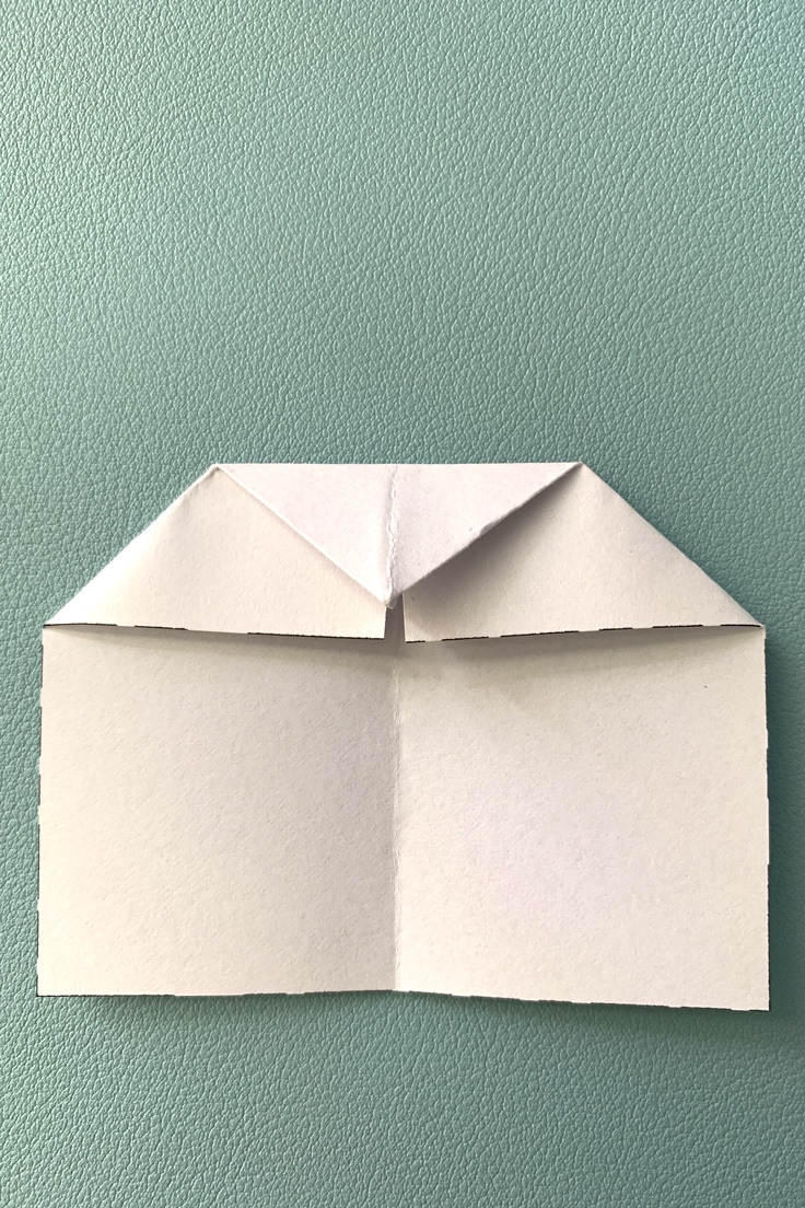 Paper with the top triangle folded down.