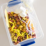 Aerial shot of a Weather Sensory Bin, filled with Froot Loops, pipe cleaners, cardstock and cotton