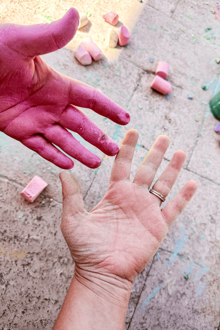 Hands that are covered in chalk dust