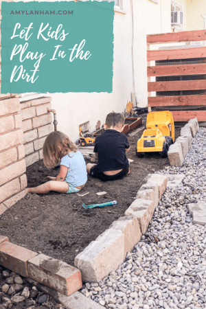 2 kids playing in the dirt