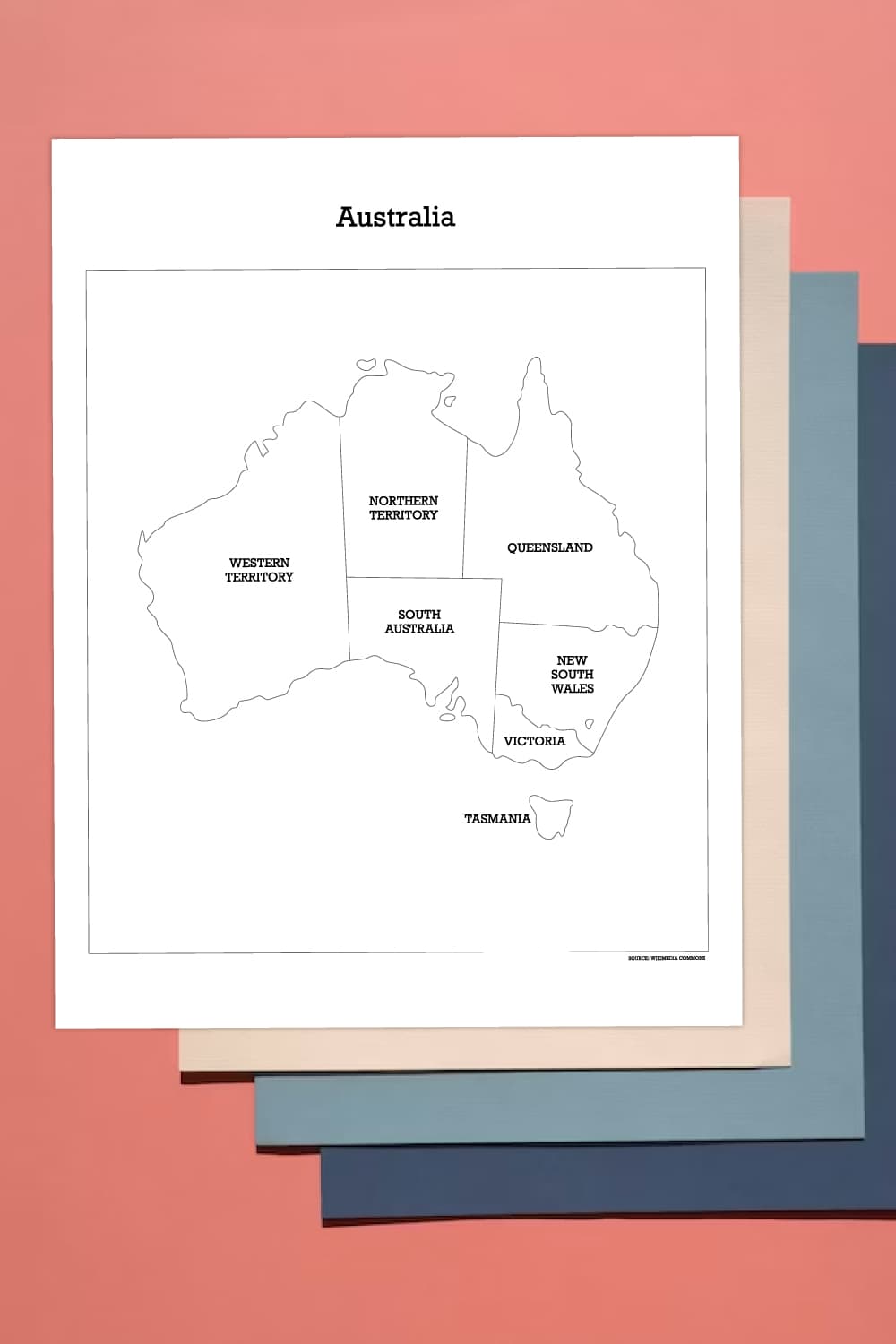 Preview of labelled map of Australia page on top of salmon colored  background with creme, blue and navy blue papers underneath.