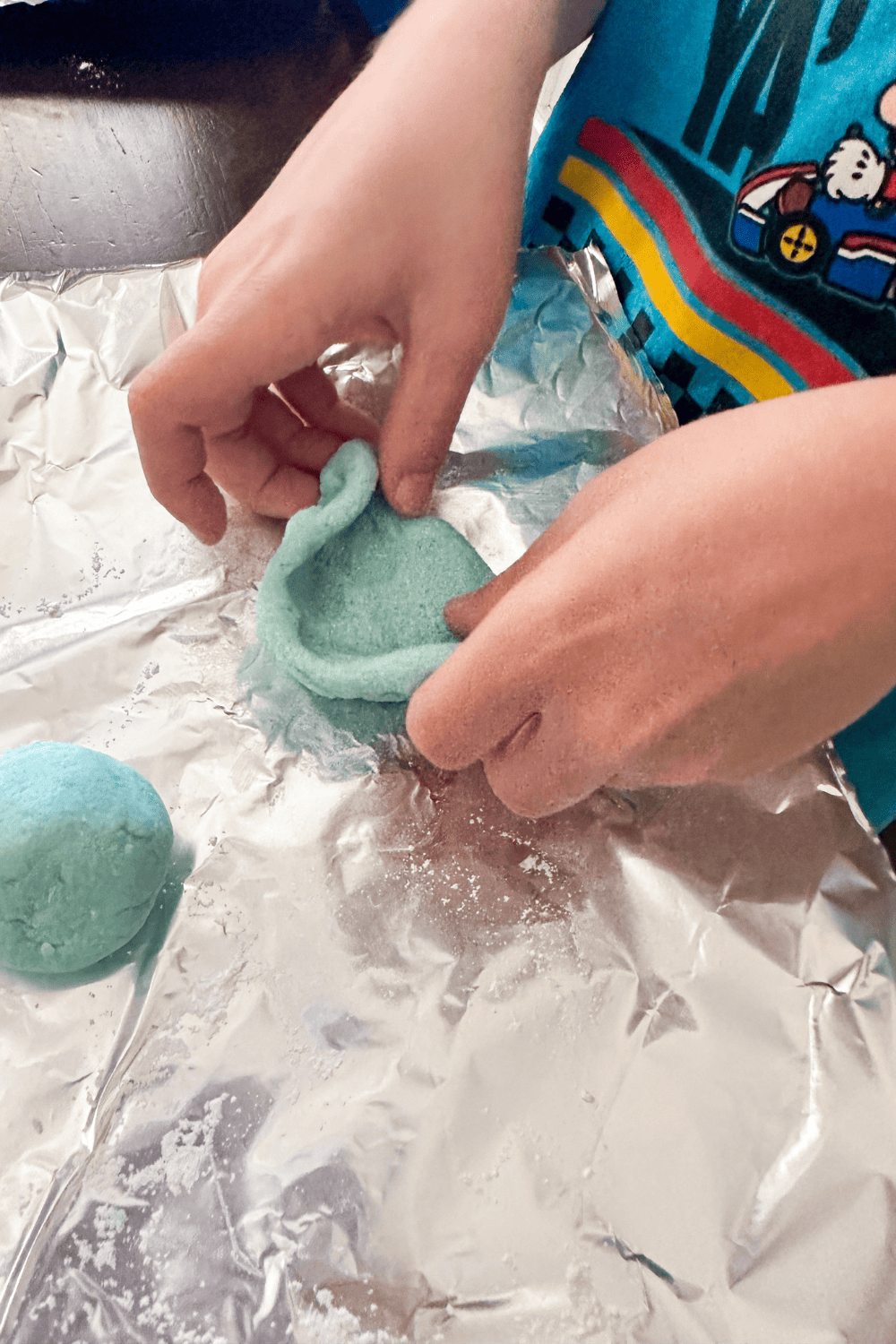 Child hands pinching the edges of salt dough