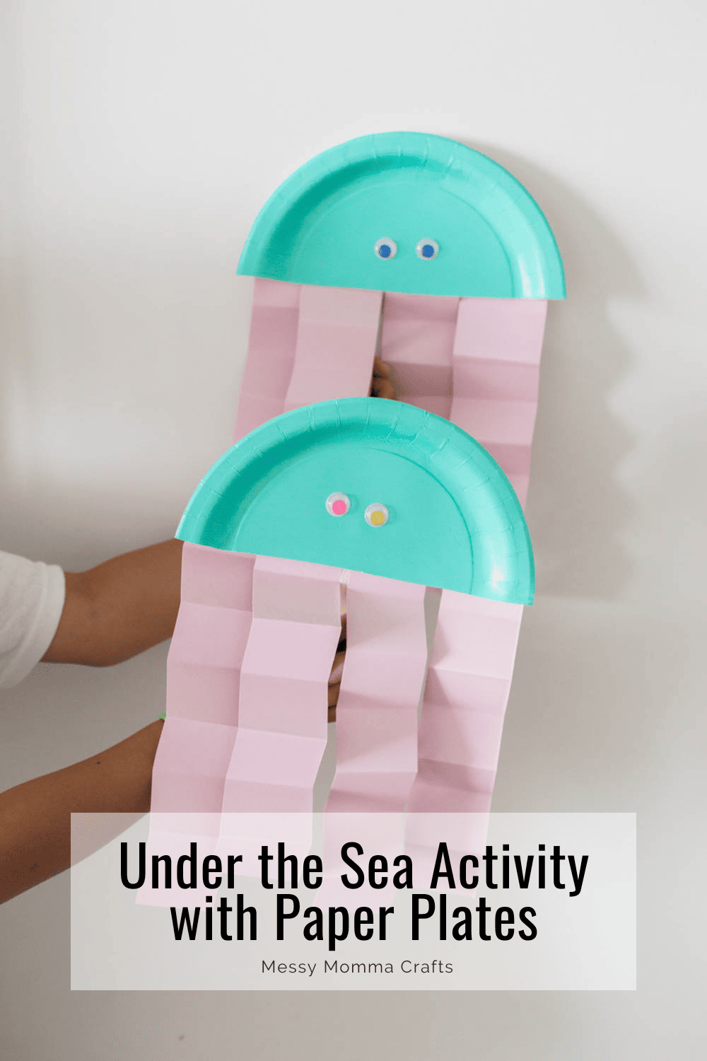 Two jelly fish crafts made of paper plates and cardstock