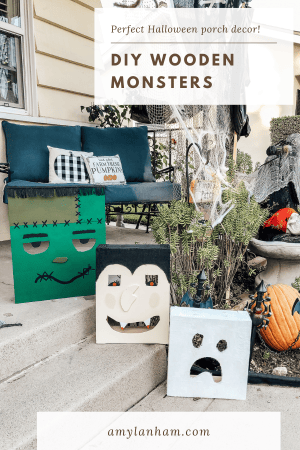 Frankenstiens monster, a vampire, and ghost made out of wood sitting on a porch.