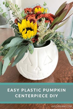 plastic white pumpkin with a floral arrangement inside