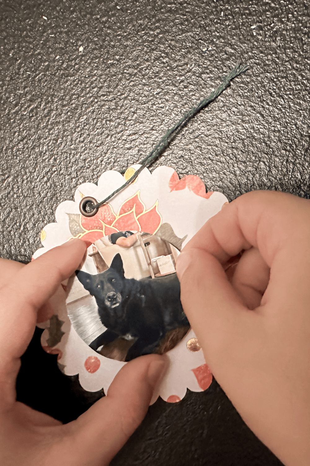 hands placing a picture of a dog onto patterned paper