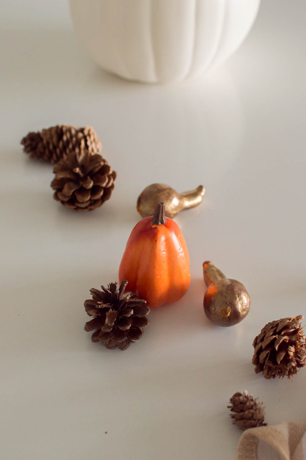 Miniature plastic gourds, pumpkins and pinecones