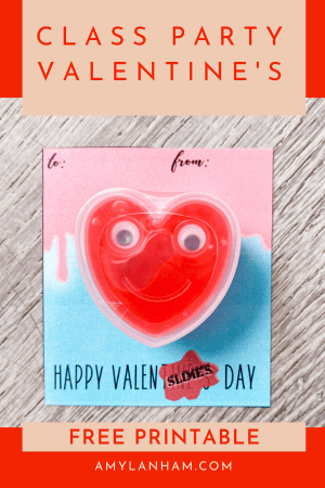 Class party Valentine that is pink and blue with a red heart slime on the front.