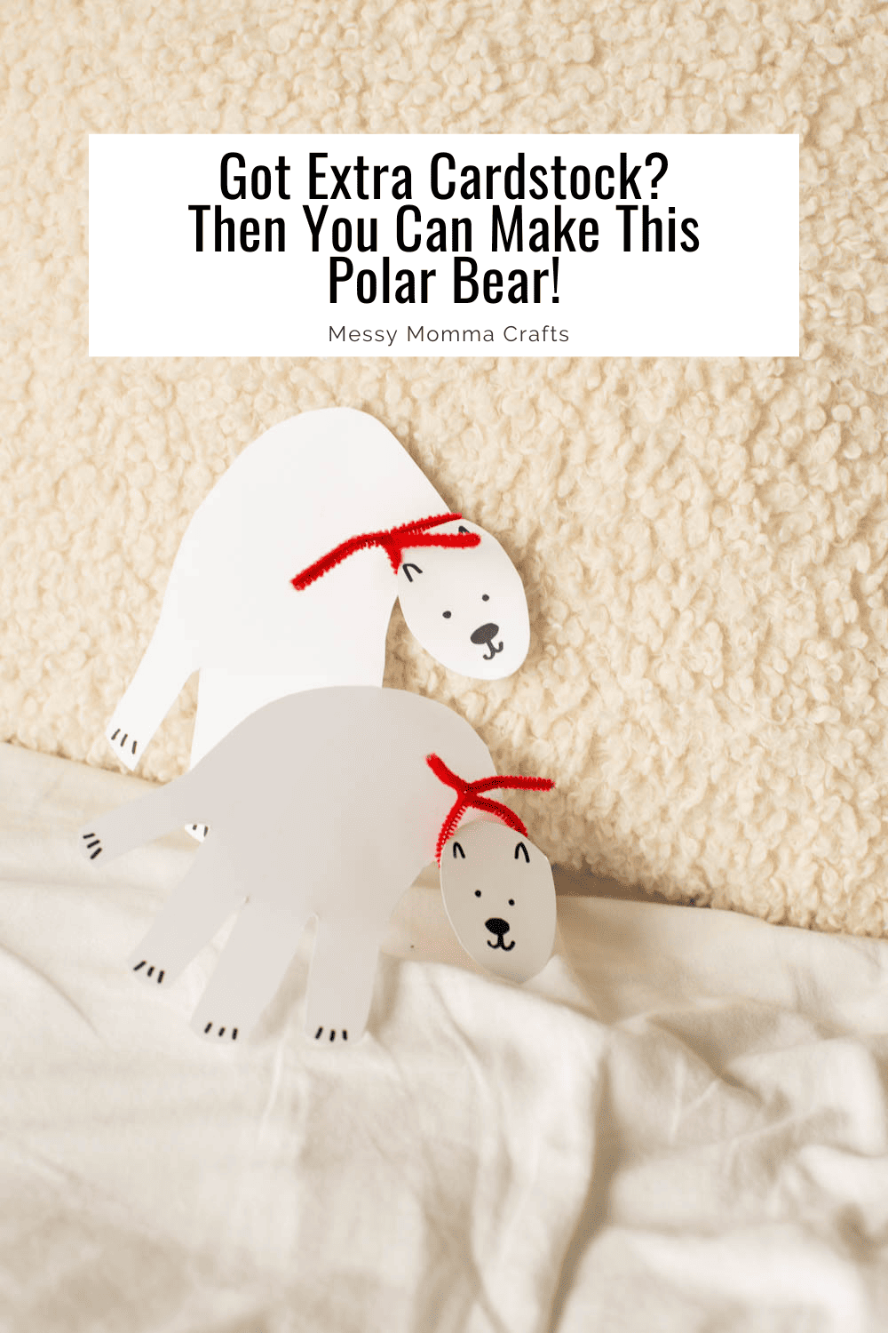 Two cardstock polar bears lean on a sherpa pillow