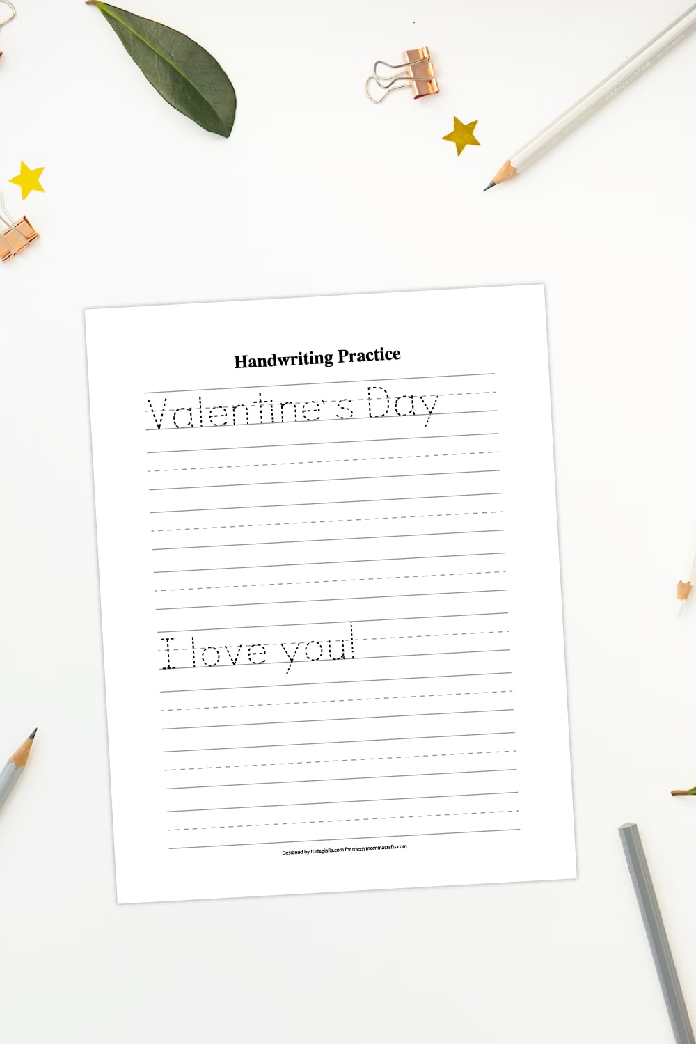 Preview of valentine writing page printable worksheet on a white background with pencils, stationery clips and gold star and leaf decorations around border. 