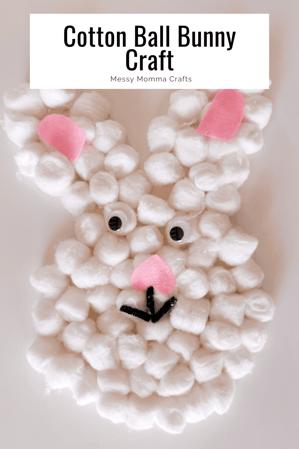 Cotton ball bunny face with pink ears, googly eyes, and a black mouth.