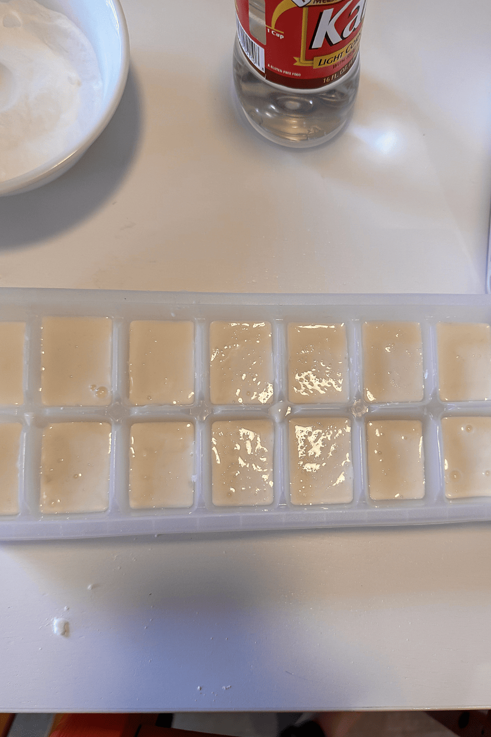 Homemade watercolor paint base in white in an ice cube tray