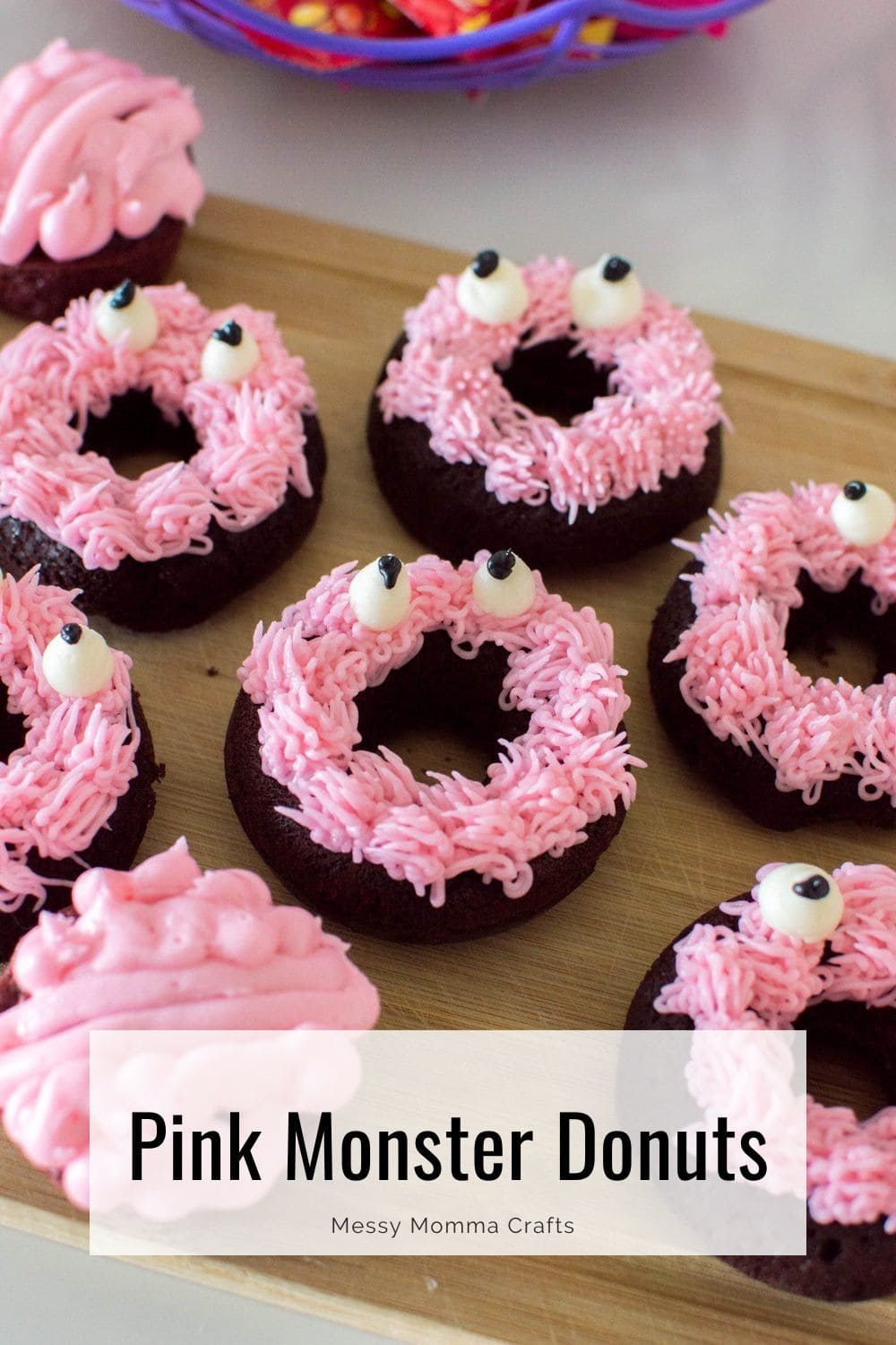 Pink monster donuts made from chocolate doughnuts and pink frosting.